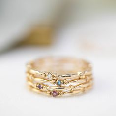 This dainty birthstone stackable ring is unlike any other, the band has a unique design all around which gives a bit of antique feel. Perfect gift for July birthdays! * Stock size: US 7 * Genuine 1.5mm garnet * Band width: ≈1.75mm * Setting size: ≈2mm * Material: 14k solid yellow gold (rose gold or white gold option available) * Made of 100% recycled precious metal and ethically sourced gemstone * Comes in a gift box with a bow ready for gifting * Handmade with love and great care in New York &l Aquamarine Stacking Ring, Aquamarine Solitaire Ring, Stackable Birthstone Rings, Citrine Birthstone, Aquamarine Birthstone, Garnet Birthstone, Topaz Birthstone, Amethyst Birthstone, Diamond Stacks