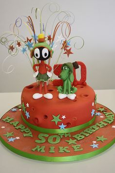 a birthday cake decorated with an image of a cartoon character on top and stars around it