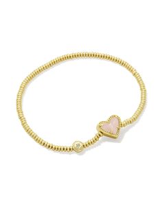 An easy addition to any wrist stack, meet the Ari Heart Gold Stretch Bracelet in Rose Quartz. Our iconic sweet heart shape meets the versatile stretch bracelet style, perfect for adding a casual but cute pop of color to your look. The best part? It’s designed to fit any wrist. Metal 14k Yellow Gold Over Brass Material Rose Quartz Closure Stretch Bracelet Size 6.5" Unstretched Circumference, 0.43"L X 0.37"W StationDue to the one-of-a-kind nature of the medium, exact colors and patterns may vary slightly from the image shown. | Kendra Scott Ari Heart Gold Stretch Bracelet in Rose | Quartz Gold Bracelet Kendra Scott, Kendra Bracelet, Teen Wishlist, Friend Ship Bracelets, Presents For Teens, Kendra Scott Rose Quartz, Birthday Presents For Teens, Wrist Stack, Gold Stretch Bracelet