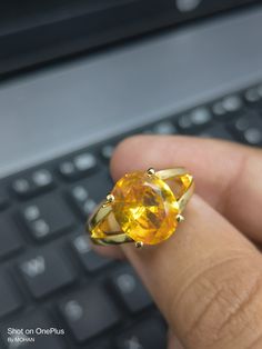 Yellow sapphire, also known as "Pukhraj" in Hindi, is a gemstone that belongs to the corundum family, just like blue sapphire. It is the yellow variety of corundum and is valued for its vibrant yellow color. Yellow sapphire is composed of aluminum oxide (Al2O3) with traces of iron that give it its yellow hue. The color of yellow sapphire can range from pale yellow to intense golden yellow. The most prized and valuable yellow sapphires typically exhibit a pure, vibrant yellow color without any hi Spiritual Yellow Gold Crystal Ring With Gemstone, Citrine Gemstone Birthstone Ring For Promise, Promise Ring With Citrine Birthstone, Citrine Birthstone Ring With Gemstone For Promise, Yellow Sapphire Round Gemstone Jewelry, Round Yellow Sapphire Gemstone Jewelry, Yellow Sapphire Gemstone Jewelry For Promise Ring, Yellow Sapphire Oval Birthstone Jewelry, Oval Yellow Sapphire Birthstone Jewelry