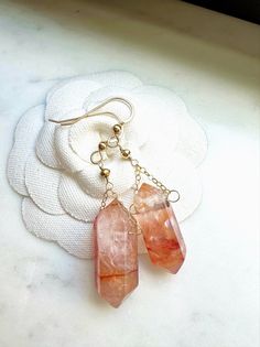 These gorgeous boho style natural red quartz crystal point earrings are a great gift for yourself or someone you love.  Genuine red crystal quartz points dangle from your choice of 14k gold fill or sterling silver earring wire. Each crystal is natural and one of a kind so there will be some variations in color and inclusions. These elegant, simple and minimalist dangly drop earrings will make a perfect gift for dressy or casual occasions and are great for bridesmaids, best friend, anniversary, s Bohemian Quartz Jewelry For Gifts, Bohemian Rose Gold Dangle Jewelry, Handmade Rose Quartz Dangle Earrings, Handmade Dainty Crystal Earrings Gift, Handmade Bohemian Crystal Earrings For Gift, Red Spiritual Dangle Earrings, Spiritual Earrings With Natural Stones For Gift, Spiritual Natural Stone Earrings For Gifts, Red Spiritual Jewelry