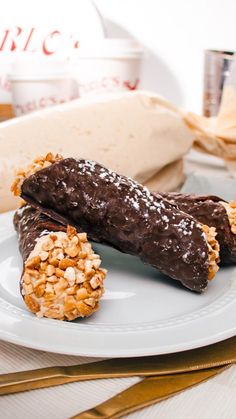 two chocolate covered pastries on a white plate