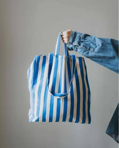 Striped Tote Bag - Blue by OMOM This bag has a spacious fabric case with a wide bottom and double handles. Get a nice inner pocket too. There you can conveniently store the net bags for the fruit and your mobile! Use this tote bag for many years and skip the disposable bags. Manufactured according to the strict require Blue Canvas Beach Bag For Shopping, Blue Large Capacity Canvas Bag For On-the-go, Large Capacity Blue Canvas Bag For On-the-go, Blue Rectangular Canvas Bag With Top Carry Handle, Blue Canvas Tote Shoulder Bag, Blue Rectangular Canvas Bag With Removable Pouch, Rectangular Blue Canvas Bag With Removable Pouch, Blue Rectangular Canvas Bag With Reinforced Handles, Blue Canvas Bucket Bag