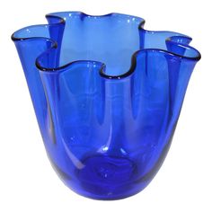 four blue glass vases sitting side by side