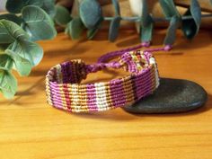 🌊 This macramé bracelet is a 𝗼𝗻𝗲-𝗼𝗳-𝗮-𝗸𝗶𝗻𝗱 accessory that 𝗳𝗲𝗮𝘁𝘂𝗿𝗲𝘀 an ethnic patchwork style and is crafted from tiny threads. Not only is it 𝘂𝗻𝗶𝗾𝘂𝗲 and eye-catching, but it is also 𝘄𝗮𝘁𝗲𝗿𝗽𝗿𝗼𝗼𝗳, making it the perfect accessory for any occasion. ◼️ 𝗪𝗛𝗬 𝗗𝗢 𝗬𝗢𝗨 𝗡𝗘𝗘𝗗 𝗧𝗛𝗜𝗦? This one-of-a-kind macramé bracelet is not just an accessory, it's a color expression for the wearer. Crafted using recycled threads, this bracelet features purple and earthy color Cheap Bohemian Purple Friendship Bracelets, Bohemian Fair Trade Friendship Bracelets As Gift, Bohemian Fair Trade Friendship Bracelets, Hippie Woven Friendship Bracelets For Beach, Hippie Woven Braided Bracelets For Beach, Hippie Pink Friendship Bracelets For Festivals, Pink Hippie Friendship Bracelets For Festivals, Pink Bohemian Braided Bracelet With Sliding Knot, Bohemian Pink Braided Bracelet With Sliding Knot