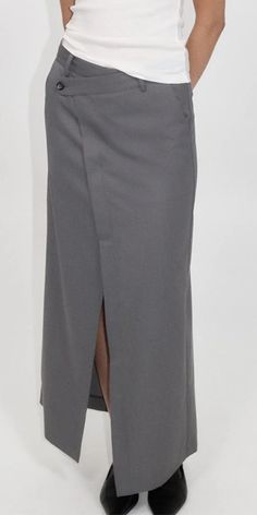 The St. Agni Deconstructed Waist Maxi Skirt elevates timeless men's tailoring with a playful feminine twist. Made from responsibly sourced wool blend, this Pewter Grey skirt features an asymmetric waist, front and back split, and a tailored mid-rise fit. Stay refined yet casual with this versatile piece. Details: Color: Pewter Grey 50% RWS Wool / 50% Recycled Poly Lining: 100% lyocell Asymmetric waist detail Center front and back split at hem Vendor Code: W24-802PGR Fits true to size Model is 5f Grey Skirt, St Agni, Pewter Grey, Blue Flats, Gray Skirt, Australian Design, Resort Wear, Long Skirt, Wide Leg Pants