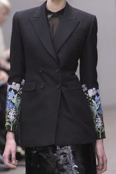 Introducing the epitome of elegance and style, our custom black cotton suiting floral embroidered jacket for women is a breathtaking piece that seamlessly blends sophistication with a touch of femininity. This double-breasted blazer exudes timeless charm and is meticulously crafted to enhance your formal ensemble, making it a perfect choice for weddings, bridesmaids, or even the bride herself. The intricately designed floral embroidery delicately graces the jacket, adding an enchanting allure to the attire. The black hue offers versatility, allowing you to pair it effortlessly with various outfits, while the tailored fit accentuates your silhouette and ensures comfort throughout the occasion. Elevate your outfit and make a statement with this bespoke, handcrafted jacket that embodies grace Elegant Black Blazer With Floral Print, Elegant Long Sleeve Suits With Floral Print, Elegant Floral Print Long-sleeved Suits, Elegant Black Floral Print Blazer, Tailored Elegant Floral Print Blazer, Tailored Floral Print Elegant Blazer, Elegant Formal Blazer With Floral Print, Elegant Fitted Floral Print Blazer, Black Spring Wedding Suit