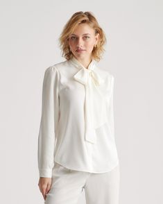 This polished blouse combines the best of both worlds. Wear the ties in a ladylike bow at the neck or leave them long and loose — whatever your mood calls for. Made of our bestselling premium mulberry silk, it has a hint of stretch for a flexible fit. Even better, it’s washable. As a bonus, silk fiber contains 18 kinds of amino acids that make it amazing for skin nourishment, hypo-allergenic, and naturally thermoregulating to help maintain body temperature. Navy Silk Skirt, Silk Fiber, Silky Shirt, Silk Cami, Lovely Tops, Tie Neck Blouse, Quarter Zip Sweater, Luxury Products, Just Run