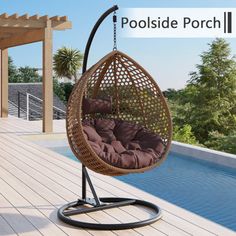 an outdoor hanging chair with cushions on the deck next to a swimming pool and pergolized porch