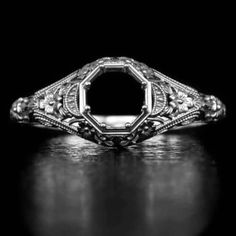 Featured here is a beautiful filigree semi-mount that is a memento of the Art Deco period! This ring is made from a mold of an original vintage piece that we have. It was one of the few rare pieces we have found with very intricate filigree and great detail. The design is timeless and as soon as we saw the original, we fell in love with the ring. The original piece was made in the 1920's and has all of the classic vintage details. The intricate filigree and engraving detail is beautiful! This looks truly like the original vintage piece as the mold was made from the old model. The pictures do not do justice to this piece because in real life you can see all of the small details together and really appreciate the rare early 1900's character of it. We certainly recommend a first hand look. Th Formal Oval Engraved Filigree Ring, Ornate Round Engraved Ring, Antique Engraved White Gold Ring With Intricate Design, Antique White Gold Engraved Ring With Intricate Design, Antique Oval Filigree Ring With Intricate Design, Antique Engraved White Gold Filigree Ring, Luxury Oval Filigree Ring With Intricate Design, Diamond Intaglio Jewelry, Round Diamond Intaglio Jewelry