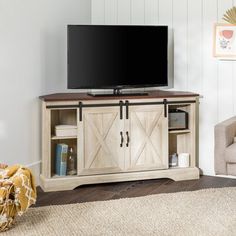 a flat screen tv sitting on top of a wooden cabinet