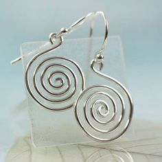 "Simple and timeless. A sterling silver hand forged spiral with large jump ring ready to hang on your favourite chain. The spiral symbol can represent the path leading from outer consciousness (materialism, external awareness, ego, outward perception) to the inner soul (enlightenment, unseen essence, nirvana, cosmic awareness). The symbol has been a favourite of many ancient tribes and people. The thickness of the wire is 1.5 mm and the diameter horizontally is about 20 mm. The length including Spiral Hand Forged Sterling Silver Jewelry, Spiral Shaped Sterling Silver Jewelry, Sterling Silver Swirl Jewelry, Sterling Silver Swirl Jewelry In Silver, Modern Spiral Sterling Silver Jewelry, Modern Sterling Silver Spiral Jewelry, Hypoallergenic Spiral Sterling Silver Jewelry, Symbolic Spiral Sterling Silver Jewelry, Minimalist Spiral Silver Jewelry