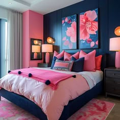 a bedroom with blue walls and pink bedding, two paintings on the wall above the bed