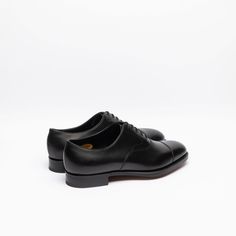 Black calf oxford shoe with stitched cap toe, double leather sole. Fitting F, last 202. Made in England Timeless Goodyear Welted Oxfords For Derby, Classic Oxford Lace-up Shoes With Rubber Heel Cap, Timeless Plain Toe Oxford For Formal Occasions, Timeless Oxford Shoes For Business, Timeless Plain Toe Oxford For Derby, Timeless Plain Toe Oxford Shoes For Derby, Leather Oxfords With Leather Sole For Derby, Timeless Leather Sole Oxfords, Goodyear Welted Almond Toe Oxfords