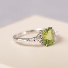 All HANDMADE ITEMS SHIP IN APPROX 8 DAYS Main Stone: Genuine natural peridot Main Stone Size: Emerald cut 6 mm x 8 mm Main Stone Weight: 1.64 carat Side Stone: CZs Height From The Ring Setting Bottom(to gemstone top): about 5.13 mm Width of Ring band Measure: gradually varied,about 1.67 to 1.91 mm Material: .925 Sterling Silver/14K White Gold/14K Yellow Gold/14k Rose Gold Engraved: Available For FreeNo more than 13 letters) Customized:Of course! Tell me what you want Includes With Order: All of Wedding Ring With Emerald Cut Peridot, Radiant Cut Green Rings With Accent Stones, Green Radiant Cut Rings With Accent Stones, Green Radiant Cut Ring With Accent Stones, Green Emerald Cut Birthstone Ring With Accent Stones, Emerald Cut Peridot Ring Gift, Emerald Cut Peridot Gemstone Jewelry, Green Radiant Cut Diamond Ring With Gemstone, Emerald Wedding Ring With Rectangular Stone And Prong Setting