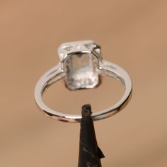 It is real natural aquamarine ring, the emerald cut aquamarine is about 5mm*7mm, weight about 0.86 carats. The basic metal is sterling silver and plated with rhodium. To change the metal to a solid gold (white/rose) or platinum is also available, please ask for a quotation if you want. You can also go to my shop Home for more elegant rings: https://www.etsy.com/shop/godjewelry?ref=hdr_shop_menu Aquamarine is the birthstone of January. More aquamarine rings: https://www.etsy.com/shop/godjewelry?r Silver Topaz Ring With Rectangular Stone For Promise, Silver Asscher Cut Diamond Ring With Bezel Setting, Silver Emerald Ring With Square Cut Solitaire, Rectangular Aquamarine Wedding Jewelry, Silver Solitaire Square-cut Emerald Ring, Silver Solitaire Emerald Ring With Square Cut, Rectangular Aquamarine Jewelry For Wedding, Rectangular Stone Topaz Ring With Prong Setting For Promise, Silver Blue Topaz Ring With Emerald Cut