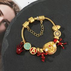 Marvel Universe brings you this exquisite 18k Gold, Silver And Stainless Steel Official Iron Man Unisex Charm Bracelet. Excellent Unisex gift for any age, gender or style type. The gold stainless steel Charms are crafted with extreme attention to every detail, the details Is what makes this charm bracelet One-Of-A-Kind and unique as you will NOT find such beautiful craftsmanship in every inch of ANY CHARM Bracelet In the industry. The Facts: This beautiful Charm Bracelet Won’t Change colors, tur Gold Symbolic Metal Charm Bracelet, Luxury Metal Charm Bracelet As A Gift, Gold Metal Jewelry For Gifts, Gold Metal Bracelet With Charms, Gold Metal Jewelry Gift, Yellow Gold Metal Charm Bracelet As Gift, Gold Alloy Bangle Bracelet, Gift Gold Charm Bracelet, Gold Stainless Steel Bangle Charm Bracelet