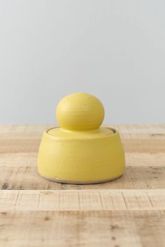 a yellow object sitting on top of a wooden table