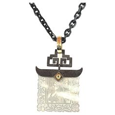 This pretty pendant features an antique, mother-of-pearl Chinese gambling counter dating back to the 18th Century. The square gaming counter with scalloped edges is set in a striking blackened silver setting with curved ends and a design that is reminiscent of an exotic gate. The pendant is further accented with an 18k yellow gold rivet and bail. This necklace is a versatile, neutral piece, wearable with casual or dressy attire. Originally carved in China for export to Britain, gaming counters w Dressy Attire, Pretty Pendant, Ancient China, Mother Pearl, Hand Engraving, Steel Chain, Rivets, Poker, Mother Of Pearl