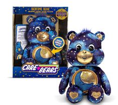 a blue and gold teddy bear with stars on it's chest in front of a box