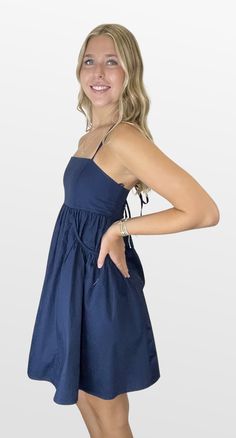 A game changer on those warm days. The bodice has a straight neckline with spaghetti straps that cross in back and create the fit. The full skirt has inset gathered pockets that add to an elevated fun style. You will look cute and beat the heat in this dress. Great for those warm gamedays! Color- Navy (Also Available in Crimson, Red, Burgundy and Orange) 100% Cotton Lining- 97% Polyester 3% Spandex Day Out Sundress With Crisscross Straps, Sundress With Crisscross Straps For Day Out, Summer Dress With Straps And Sweetheart Neckline, A-line Sundress With Adjustable Straps, A-line Sundress With Straps, Summer Dress With Sweetheart Neckline And Straps, Summer Sundress With Sweetheart Neckline, Chic Dress With Spaghetti Straps And Crisscross Details, Chic Dress With Spaghetti Crisscross Straps