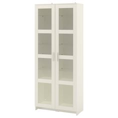 a white cabinet with glass doors and shelves