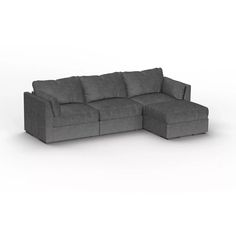 a gray sectional couch sitting on top of a white floor