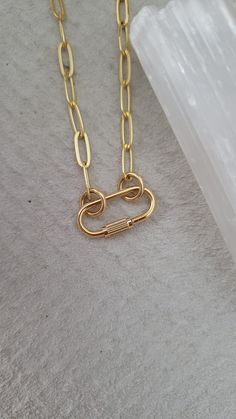 "Mini lock necklace - heavy 16k gold plated over brass - 16\" + 2\" extension - screw charm about 3/4\" long and 1/2\" wide (please see photo for exact mm) - ☆ the inner diameter of the rings/circle that slide into the Carabiner are 5mm, if you would like a larger size ring or specific mm message me your request ☆ Style option to purchase the necklace as pictured or the Carabiner only ♡ for the minimalist style person or everyday layer gal ◇ Another mini Carabiner option here https://www.etsy.com/listing/795710907/mini-carabiner-necklace-screw-necklace?ref=shop_home_active_1 * If you would like a different length of chain can select \"carabiner only\" and purchase your desired chain length seperate here ⬇️ https://www.etsy.com/listing/773867462/carabiner-chain-paperclip-chain?ref=shop_home Carabiner Necklace, Necklace Lock, Lock Necklace, Unusual Jewelry, Circle Ring, Dallas Tx, The Minimalist, Paper Clip, Minimalist Style