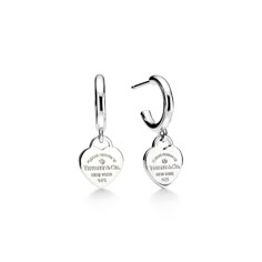 Inspired by a key ring we debuted in 1969, the Return to Tiffany collection is famous for its signature motif. These sterling silver earrings pair the iconic heart tag with meticulously crafted hoops. The heart tags are each hand set with a diamond. Wear on their own or paired with small studs for maximalist style. Sterling silver with diamonds; Carat total weight .01; Motif size, mini | Return To Tiffany® Hoop Earrings in Sterling Silver with Diamonds, Mini Tiffany And Co Earrings, Tiffany And Co Jewelry, Tiffany Earrings, Return To Tiffany, Heart Tag, Tiffany And Co, Jewelry Lookbook, Girly Jewelry, Dream Jewelry