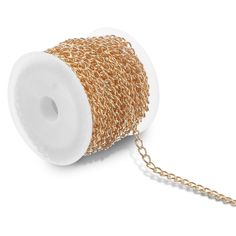 a spool of gold chain on a white background