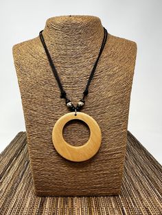 Step into a world where fashion meets nature with our Beige Wooden Circle Pendant Necklace. This accessory isn't just a piece of jewelry; it's a wearable work of art that perfectly combines the timeless beauty of wood with a contemporary, minimalist aesthetic. Ideal for those who appreciate the understated elegance of simplicity and the unique character of natural materials. The circular pendant, carefully handcrafted from wood, dangles elegantly from an adjustable cord, providing a comfortable Nickel-free Unique Jewelry For Everyday, Unique Nickel-free Jewelry For Everyday Use, Minimalist Jewelry In Natural Tones As A Gift, Brown Pendant Jewelry For Everyday Use, Adjustable Everyday Necklace With Large Pendant, Adjustable Large Pendant Necklace For Everyday, Everyday Adjustable Necklace With Large Pendant, Elegant Round Natural Jewelry, Everyday Use Brown Pendant Jewelry