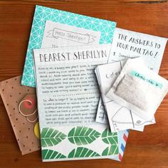 several different types of paper on top of a wooden table