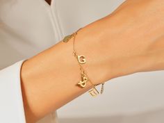 A Letter Charm Bracelet in 14k Gold is a personalized and stylish accessory that holds sentimental value. This bracelet features individual charms crafted from high-quality 14k gold, showcasing a radiant and timeless elegance. The charms are intricately designed in the form of letters, allowing for personalized combinations that can spell out names, initials, or meaningful words. FEATURES • Made to Order • Gold Kt: 14k Solid Gold, 18k Solid Gold • Gold Color: Rose Gold, Yellow Gold, White Gold • Dainty Yellow Gold Name Bracelet With Initials, Elegant Initials Charm Bracelet For Anniversary, Elegant Charm Bracelet With Initials For Anniversary, Personalized Yellow Gold Name Bracelet In Fine Jewelry Style, Elegant Adjustable Initials Charm Bracelet, Elegant Engraved Charm Bracelet, Dainty 14k Gold Bracelet For Personalized Gift, Dainty 14k Gold Bracelet As Personalized Gift, Elegant Gold Charms With Initials