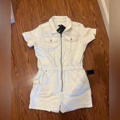 Brand New Never Worn Before White Denim Romper. Front Zipper, Stretchy Waist, Overall Comfortable Stretch Fabric. Does Have A Slight Stain On The Left Pocket (See Pictures) From Being In Storage. White Relaxed Fit Denim Jumpsuit For Summer, Fitted White Denim Jumpsuit, Summer White Cotton Denim Jumpsuit, White Denim Jumpsuit With Pockets, White Relaxed Fit Denim Overall Jumpsuit, Trendy White Cotton Denim Jumpsuit, White Cotton Denim Jumpsuit For Summer, Trendy White Denim Jumpsuit For Spring, Trendy White Relaxed Fit Jumpsuits And Rompers