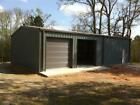 two garages in the middle of a field with trees and grass on both sides