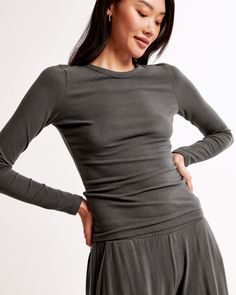 Slim-fitting long-sleeve tee in our soft cozy lounge knit fabric and tuckable length, featuring a crew neckline and all-over texture detail. Cozy Fitted Tops In Solid Colors, Cozy Long Sleeve Stretch Tops, Cozy Stretch Long Sleeve Tops, Versatile Crew Neck Top For Loungewear, Versatile Long Sleeve Ribbed Top, Cozy Fitted Tops For Layering, Chic Long Sleeve Crew Neck Top For Loungewear, Fine Knit Crew Neck Top For Loungewear, Versatile Crew Neck Tops For Fall