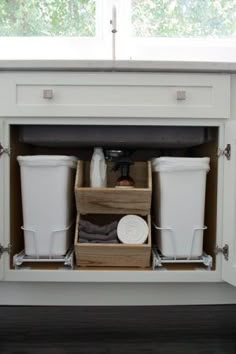 an open cabinet in the middle of a kitchen