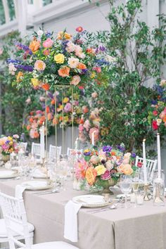 the table is set with flowers and candles