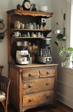 an old fashioned coffee maker on top of a wooden dresser