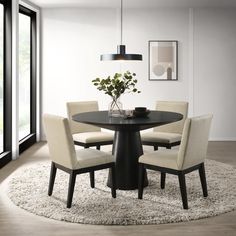 a round dining table with four chairs and a vase on the top, in front of a large window