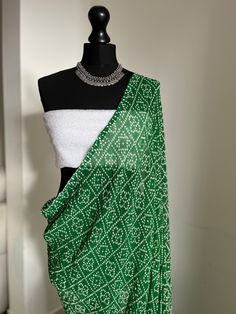 Green Bhandani saree with white sequinned blouse. Soft to drape and easy to style Festive White Pre-draped Saree With Unstitched Blouse, White Blouse With Dupatta For Eid, Elegant Bandhani Print Dupatta For Designer Wear, Elegant Designer Wear Dupatta With Bandhani Print, White Blouse With Traditional Drape For Parties, Elegant Bandhani Print Pre-draped Saree For Festive Occasions, Elegant Festive Pre-draped Saree With Bandhani Print, Elegant Festive Pre-draped Bandhani Saree, Transitional White Georgette Blouse Piece