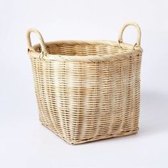 a wicker basket with handles on a white background