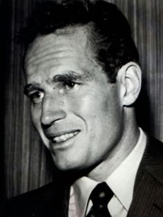 a black and white photo of a man in a suit