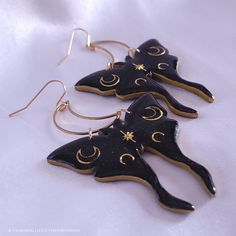 Subtle holographic shimmer accentuates the black polymer clay; gold moons are encased in resin to give strength, shine, and a professional finishing touch. These earrings are sure to make a statement and leave an impression! They measure just under 3 inches long and about 2 inches wide, hang from stainless steel crescent moons and French ear hooks. They are a medium weight, so I do not recommend them for novice earring wearers. The earrings are tough, but I do not recommend wearing in the shower Black Celestial Earrings For Gift, Adjustable Black Crescent Earrings, Black Moon-shaped Earrings For Gift, Black Moon Shaped Earrings For Gift, Handmade Black Crescent Earrings, Handmade Black Moon-shaped Earrings, Handmade Black Moon Earrings, Handmade Magical Black Jewelry, Handmade Black Magical Jewelry