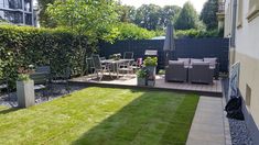 a backyard with lawn and patio furniture