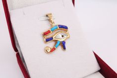 Colored Eye of Horus 18K gold Pendant | handmade jewelry Egyptian jewelry evil eye pendant mythology jewelry eye necklace Horus charm 3.2 Gr Weight Approximate : 3.2 Gr Height : 1.2" = 31 mm Width : 1" = 27 mm ✔ IT IS Tested & SIGNED WITH THE EGYPTIAN Gold Government HALLMARK FOR 18K GOLD to Ensure      Authenticity. ✔ Lovely gift idea ABSOLUTELY GORGEOUS, LOOKS FABULOUS ON. ✔ 100% Egyptian handmade. ✔ Condition: A brand-new, exactly as on the photos. ★ GIFTS ✔ All items are packaged in a velvet Gold Evil Eye Amulet Jewelry, Brass Evil Eye Jewelry As A Gift, Brass Evil Eye Jewelry For Gifts, Evil Eye Brass Jewelry As A Gift, Gold Evil Eye Pendant Jewelry, Symbolic Pendant With Diamond Eyes, Symbolic Eye-shaped Jewelry Gift, Symbolic Evil Eye Pendant Jewelry, Gold Plated Evil Eye Amulet Jewelry