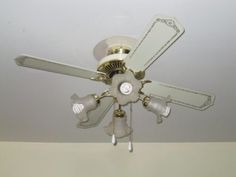 a ceiling fan with three blades on it