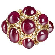 This dome ring is the perfect way to add a touch of glamour to your wardrobe. With 9 cabochon rubies and a total weight of 16.78 carats, this piece will look great with any outfit. The 18 karat yellow gold setting gives it an antique feel that goes well with any outfit, while still being modern enough to wear every day. This ring is perfect if you want something that is a little more subtle than a traditional ruby ring, but still want to show off your love for the gemstone! US 6.5 Resizing is av Luxury Domed Ruby Ring In Elegant Style, Luxury Classic Cabochon Ruby Ring, Luxury Cabochon Dome Ring In Fine Jewelry Style, Luxury Cabochon Ruby Ring, Luxury Vintage Oval Cabochon Dome Ring, Luxury Ruby Ring With Cabochon Cut, Luxury Ruby Cabochon Diamond Ring, Luxury Cabochon Ruby Ring For Anniversary, Luxury Ruby And Diamond Oval Cabochon Ring