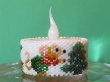 a small white candle is sitting on a glass plate