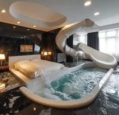 a bedroom with a slide in the middle of it and a large bed on the other side